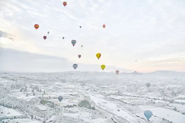 Deurstickers Colorful Hot Air Balloons Over Cappadocia During Winter in Turkey © panithi33