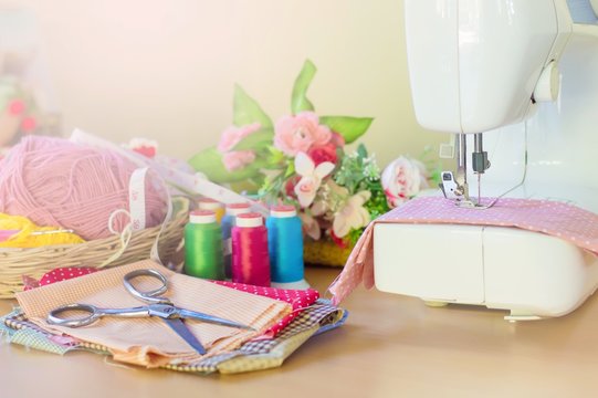 Sewing machine on the table with accessory for sewing