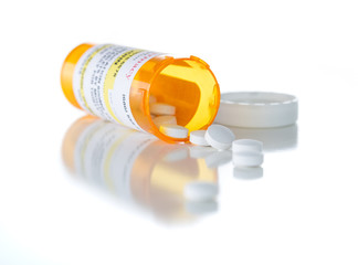 Non-Proprietary Medicine Prescription Bottle and Spilled Pills Isolated on a White Background.
