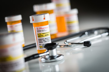 Several Non-Proprietary Medicine Prescription Bottles Abstract with Stethoscope.