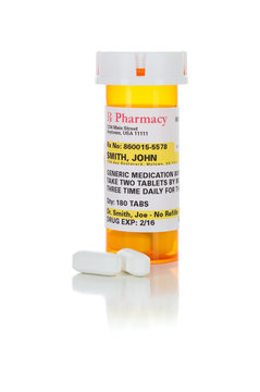 Non-Proprietary Medicine Prescription Bottle and Pills Isolated on a White Background.