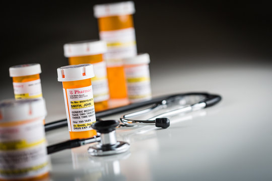 Several Non-Proprietary Medicine Prescription Bottles Abstract with Stethoscope.
