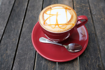 Hot caramel macchiato on wooden table