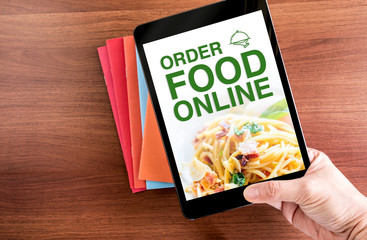 Close up Two hand holding tablet with order food online word, Di