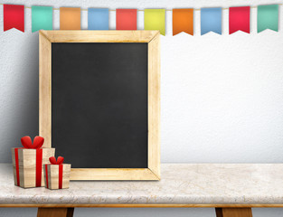 Blank blackboard with gift box and colorful flag banner on marbl