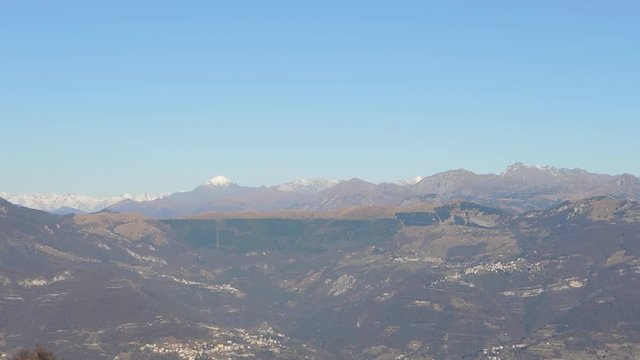 Great landscape with fantastic blue sky on the Orobie Alps and Padana plain a dry winter season without snow. Panorama from Linzone Mountain, Bergamo, Italy. 
