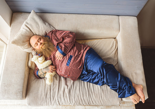 Sleepy Guy Lying On Couch