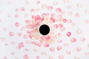 Coffee cup and pink roses petals pattern. Flat lay, top view