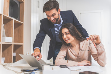 Joyful man buying granite objects in store