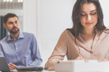 Fototapeta premium Skillful saleswoman working in design interior store