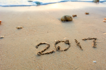 Year 2017 written at the sand beach