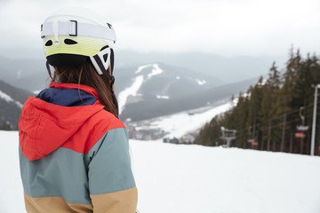 Back view image of young lady snowboarder