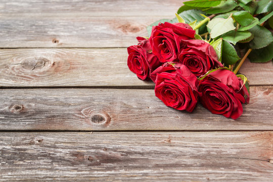 bouquet of red roses on wood background. Valentines Day backgrou