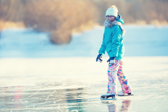 
Ice skating. Young girl is skating on a natural frozen lake.