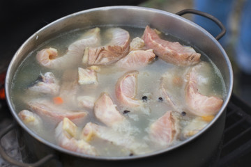 Сauldron with fish soup at outdoor
