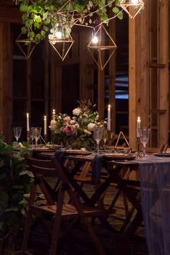 Decoration table before a banquet in a wooden barn.