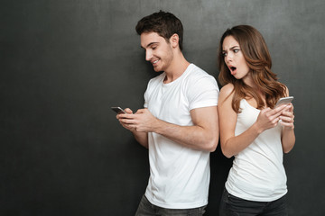Young Couple with phones in studio