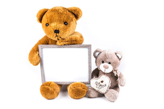 Brown and grey fuzzy teddy bears with a grey frame isolated on a white background