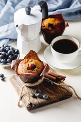 Blueberry muffins and fresh fruit, a cup of black coffee. Tasty