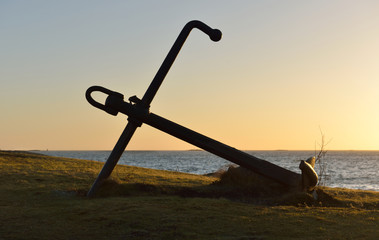 Old anchor at sunset. Island Liuskasaari