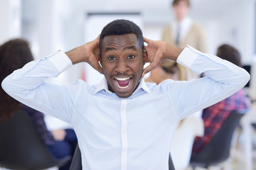 Obraz premium Furious black businessman tired of working on project at office.