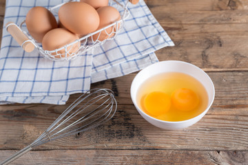 Egg yolk for cooking on white bowl.