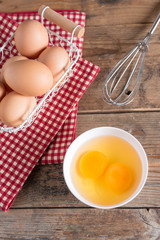 Egg yolk for cooking on white bowl. Top view.