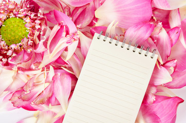 Open blank diary on blooming pink lotus flower.