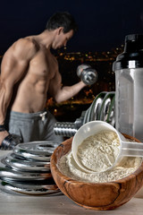 Protein shake Vanilla flavor accompanied by weights and sportsme