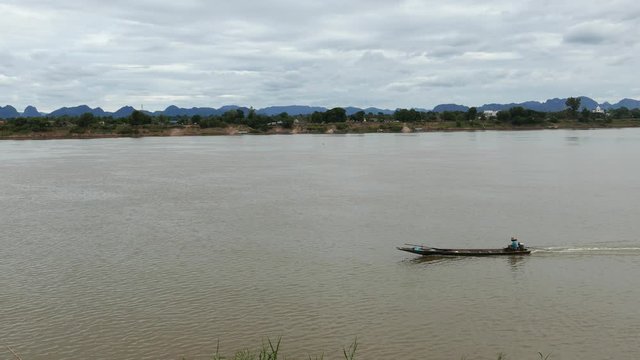 Fishermen boat floating on the majestic Mekong River.