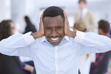 Obraz premium Furious black businessman tired of working on project at office.