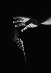 Smoke and hand on a black background