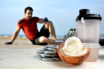 Protein shake Vanilla flavor accompanied by weights and sportsme