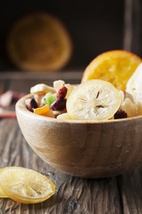 Homemade succade: lemon, orange, kiwi, banana, mango on the wood