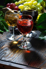 assortment different wine on wooden background, vertical
