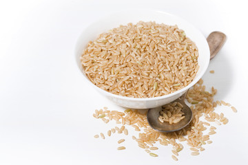 brown rice in a bowl on a white background