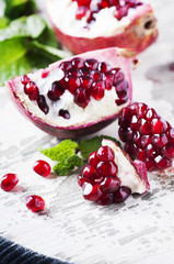 Red sweet pomegranate on the wooden table