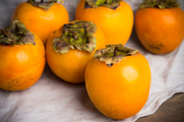 Fresh persimmon fruit on wooden table