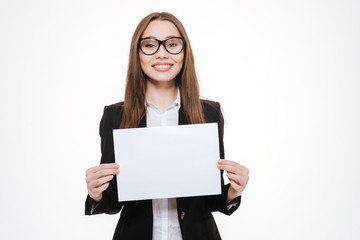 Fototapeta premium Smiling businesswoman holding blank board isolated on a white background