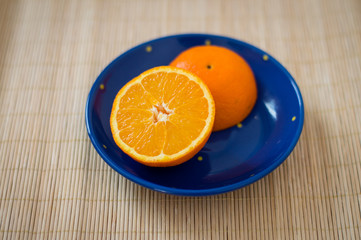 half orange on a blue plate