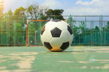Fototapeta na wymiar The ball on the middle of futsal court with sun flare