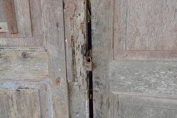 master key lock on old wooden and decay door house