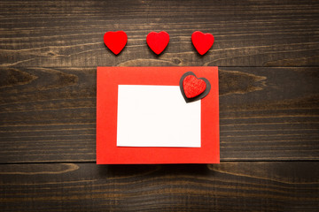Valentine's day background. Valentine's Day card with red hearts on the wooden desk.