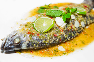 Steamed Fish in Lemon Sauce on white plate