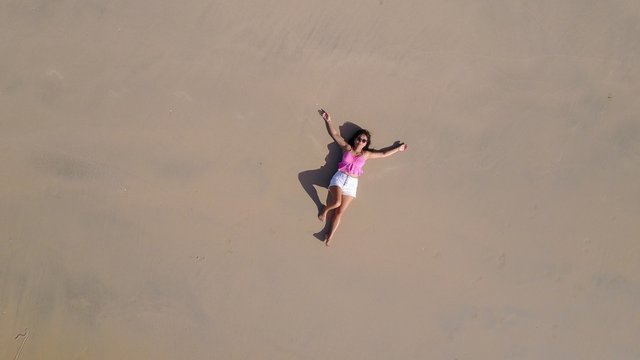 Woman lying on sand