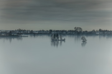 Landscape Lake and trees with refelections in the mist