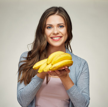 smiling woman with long hair holding banana.