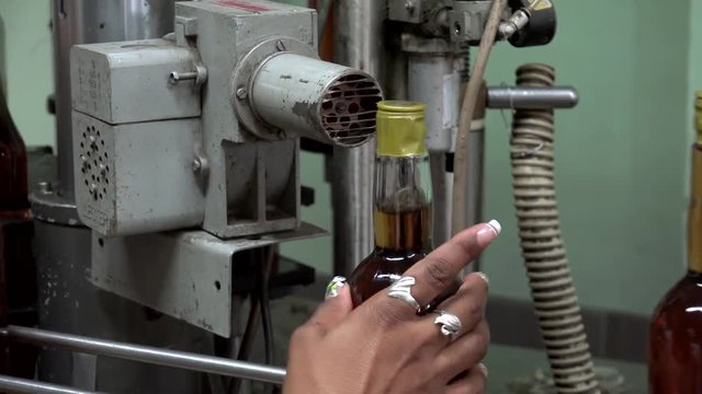 Semi-automatic bottling line in the rum factory. Pinar del Rio, Cuba