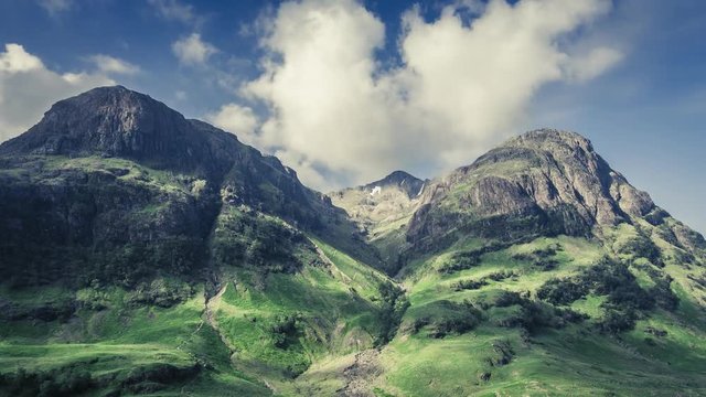 Stunning dawn over the green mountains of Glencoe in Scotland, 4k, timelapse