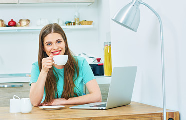 woman work at home kitchen with laptop